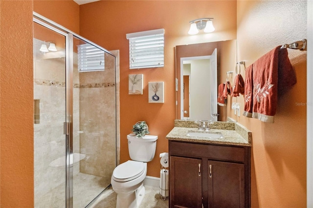 bathroom with vanity, an enclosed shower, tile patterned floors, and toilet