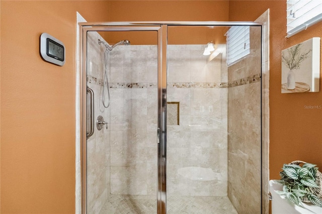 bathroom with plenty of natural light and walk in shower