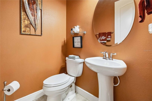 bathroom featuring tile patterned floors and toilet