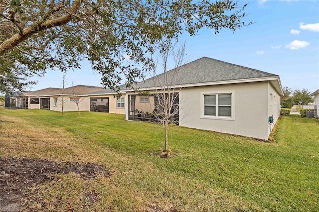 rear view of house featuring a yard