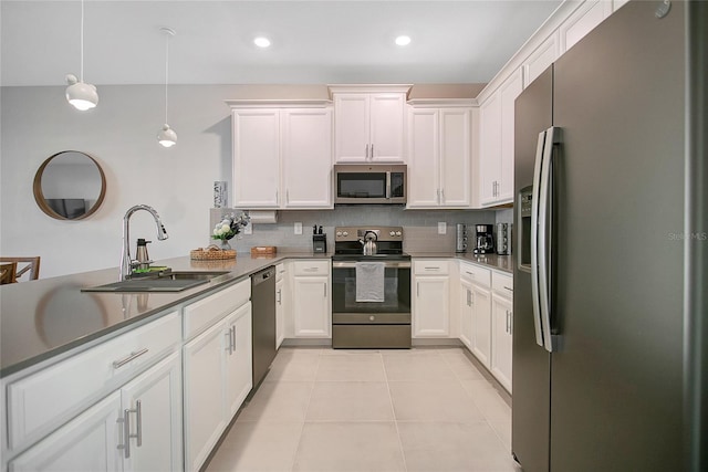 kitchen with sink, decorative light fixtures, light tile patterned floors, stainless steel appliances, and backsplash