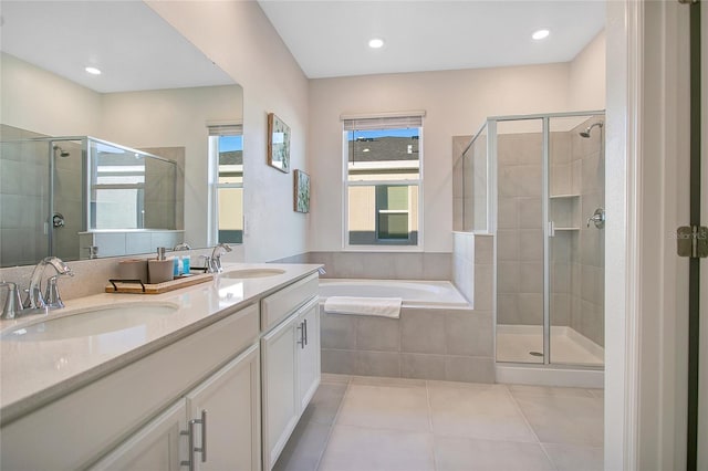 bathroom featuring independent shower and bath, vanity, and tile patterned floors