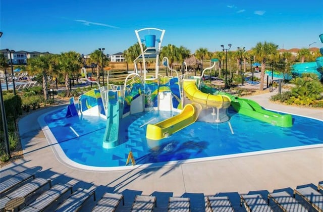 view of swimming pool featuring a playground