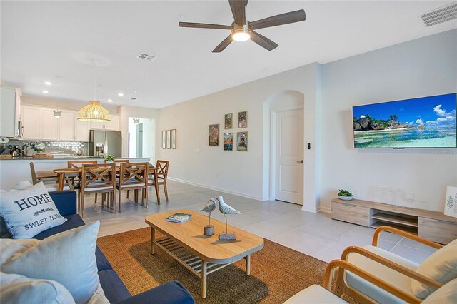 tiled living room with ceiling fan