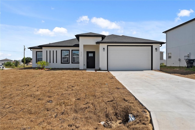 view of front of home featuring a garage and a front yard