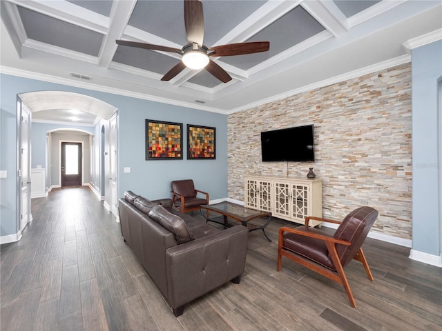 living room featuring coffered ceiling, wood-type flooring, ornamental molding, ceiling fan, and beam ceiling