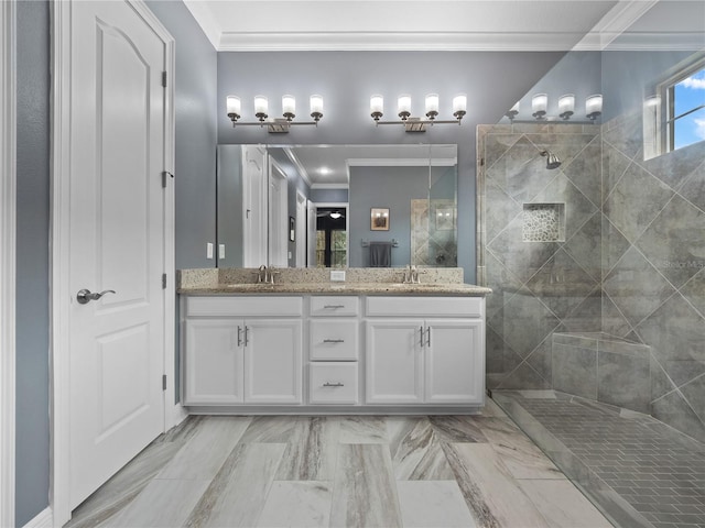 bathroom featuring vanity, crown molding, and tiled shower