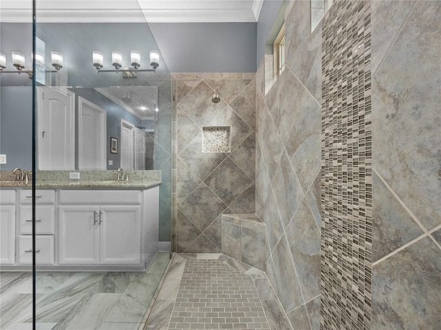 bathroom featuring vanity, ornamental molding, and a tile shower