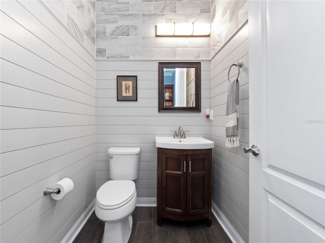 bathroom featuring vanity, toilet, and hardwood / wood-style floors