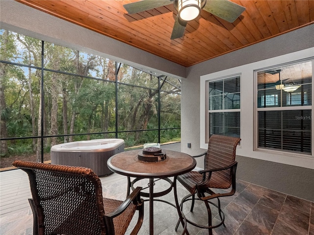 sunroom / solarium featuring wood ceiling and ceiling fan