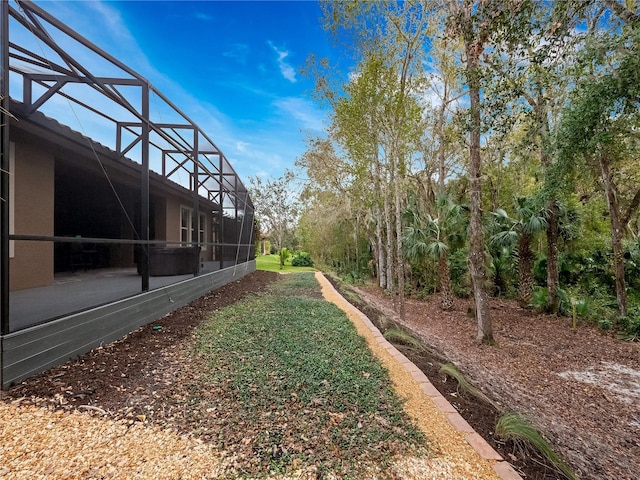 view of yard with glass enclosure