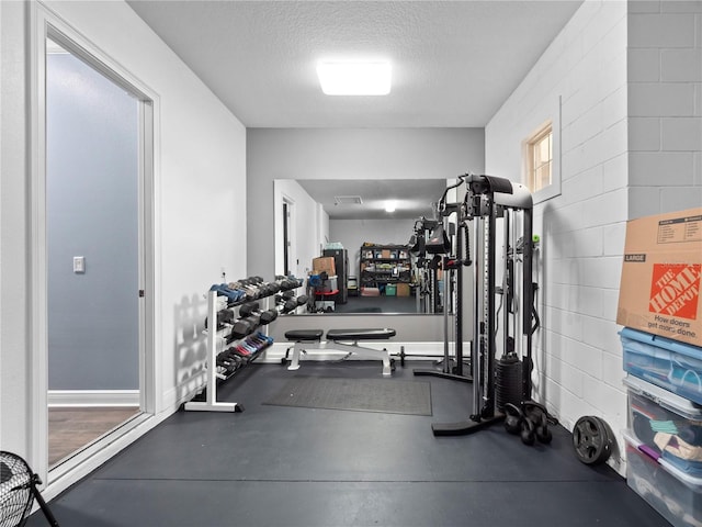 workout area with a textured ceiling