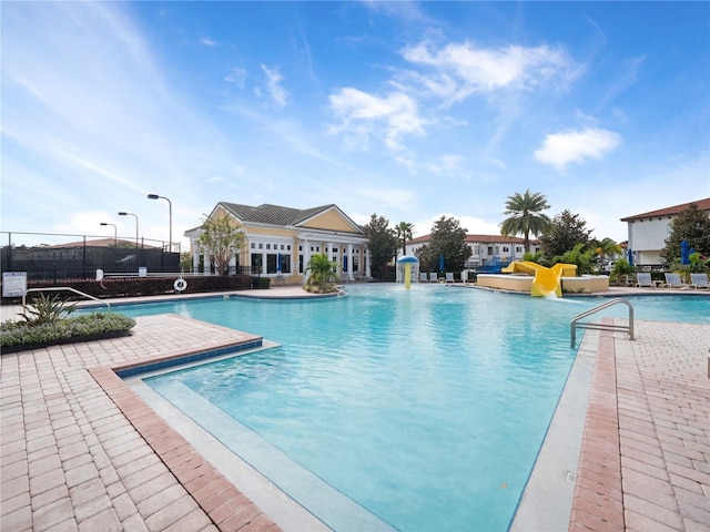 view of pool with a patio area and pool water feature