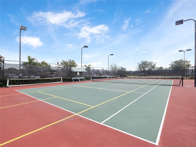 view of tennis court with basketball hoop