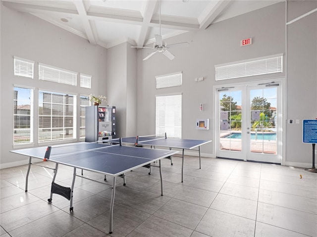 recreation room featuring a wealth of natural light, french doors, beamed ceiling, and a high ceiling