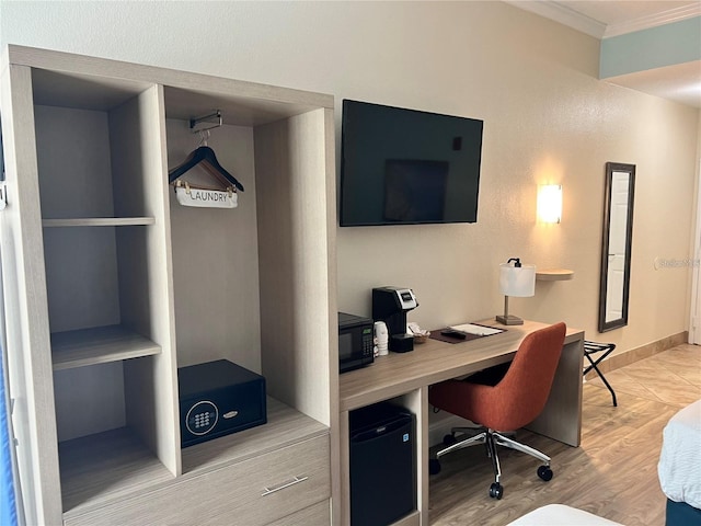 office area with crown molding and light hardwood / wood-style flooring