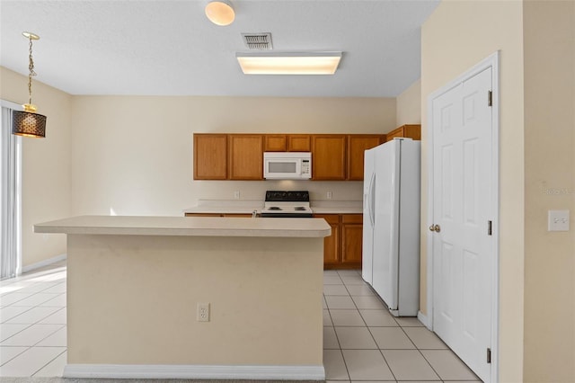 kitchen featuring white appliances, a kitchen island, decorative light fixtures, and light tile patterned flooring