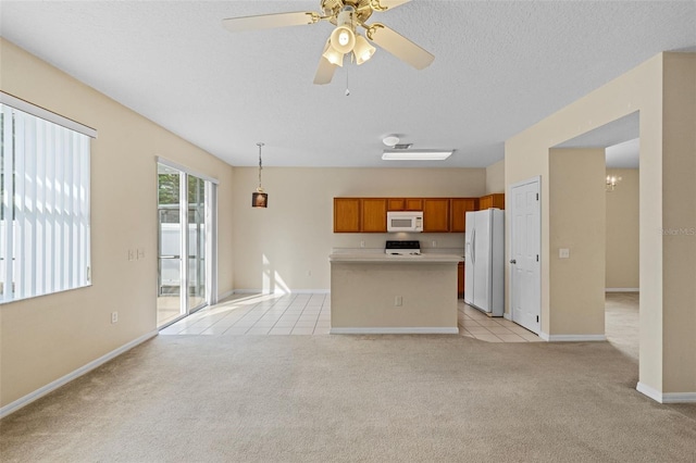 unfurnished living room featuring ceiling fan, light colored carpet, and a textured ceiling