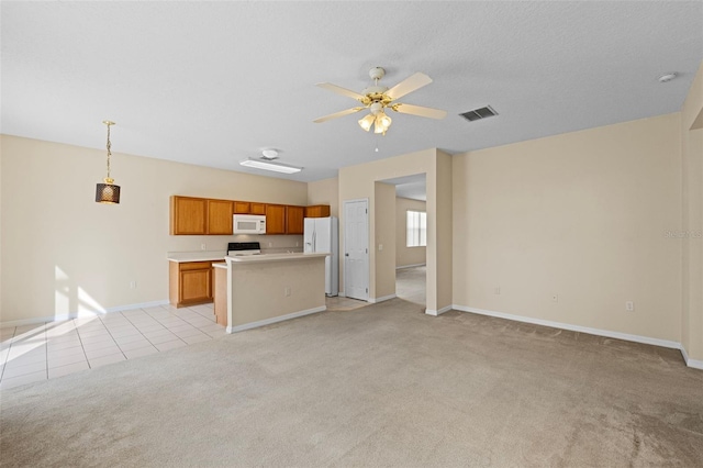 unfurnished living room with light carpet and ceiling fan