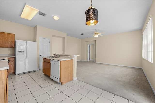 kitchen with decorative light fixtures, sink, light colored carpet, ceiling fan, and white appliances