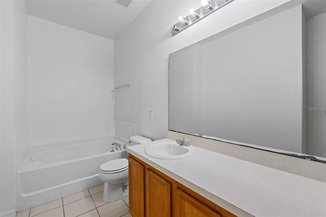 bathroom featuring vanity, tile patterned floors, a tub, and toilet