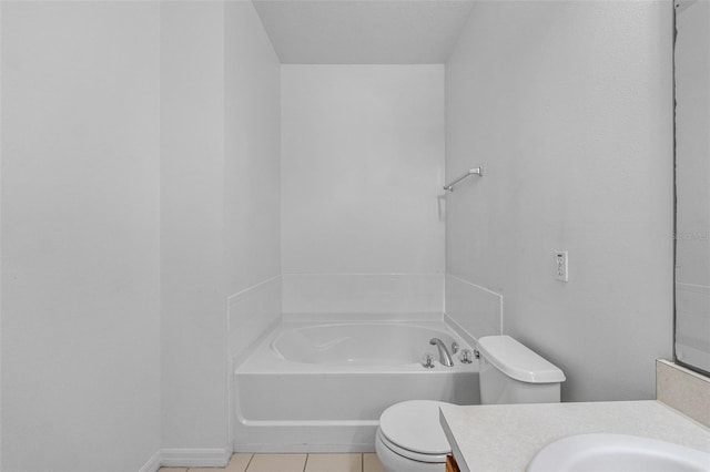 bathroom with tile patterned flooring, vanity, a washtub, and toilet