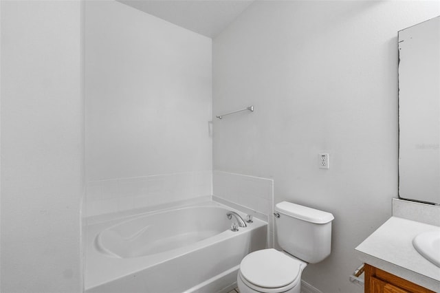 bathroom with vanity, a bath, and toilet