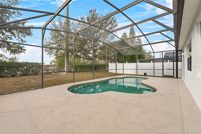 view of swimming pool featuring a patio and glass enclosure