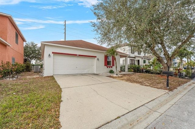 view of front of house with a garage and central AC unit