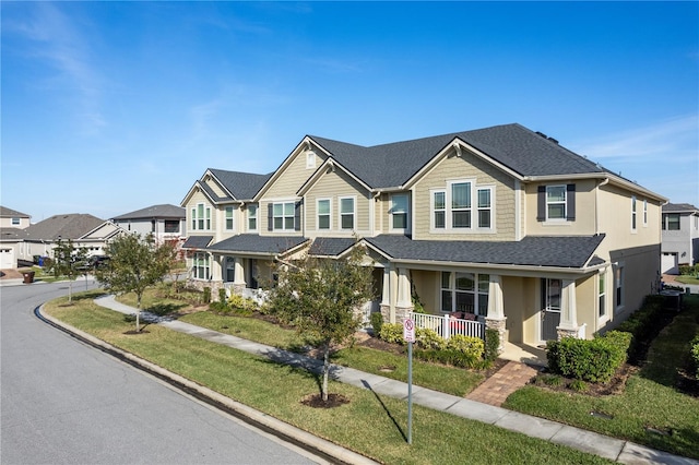 view of front facade featuring a front yard and covered porch