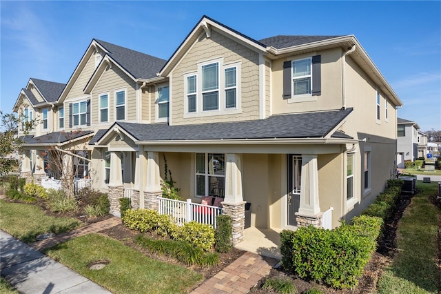 craftsman-style house with central air condition unit and covered porch