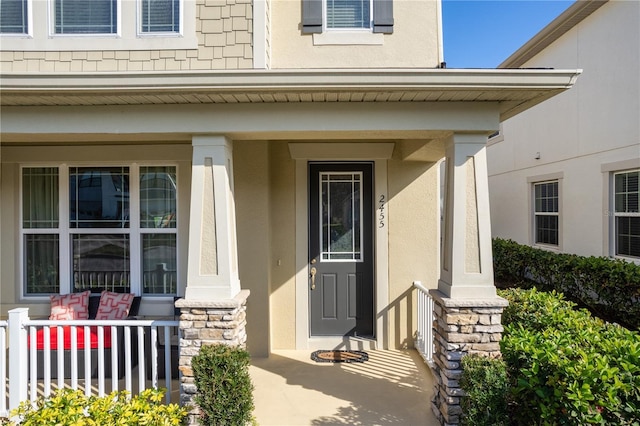 entrance to property featuring covered porch