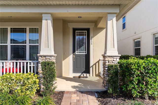 view of exterior entry featuring a porch