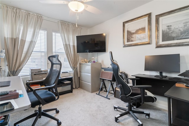 carpeted home office with ceiling fan and plenty of natural light