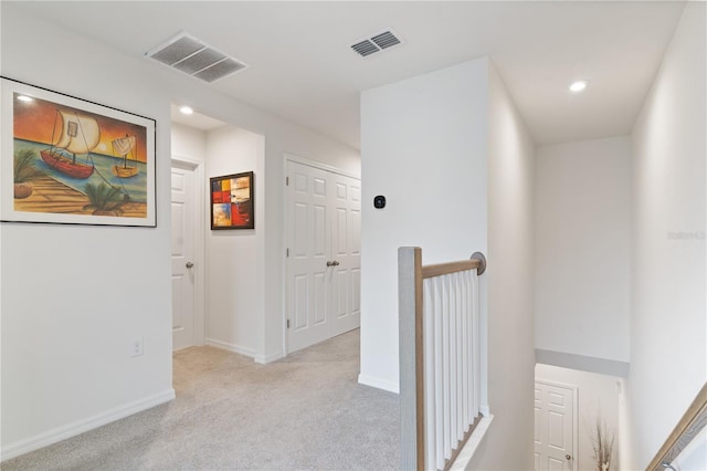 hallway featuring light carpet