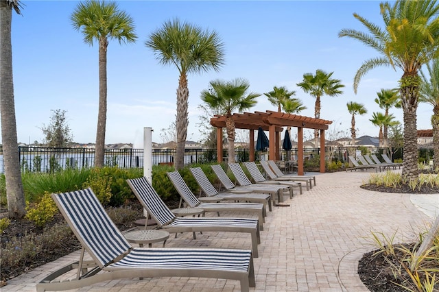 surrounding community featuring a water view and a pergola