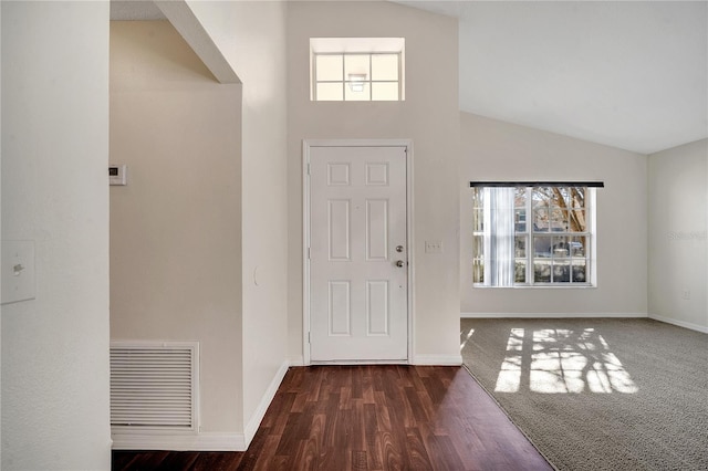 foyer entrance with lofted ceiling and dark hardwood / wood-style floors