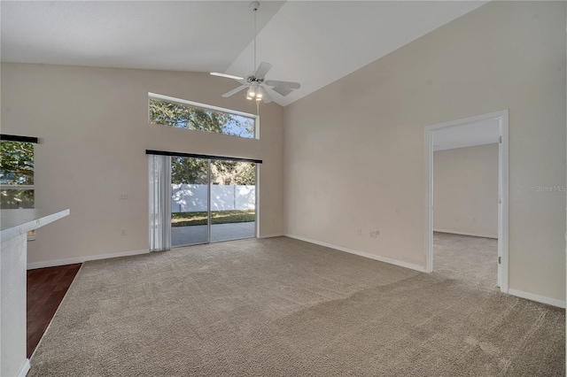 unfurnished living room featuring ceiling fan, carpet, and high vaulted ceiling