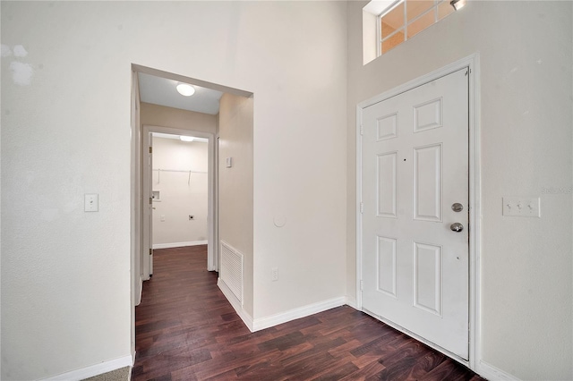 entryway with dark hardwood / wood-style flooring