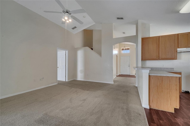 kitchen with high vaulted ceiling, dark carpet, and ceiling fan