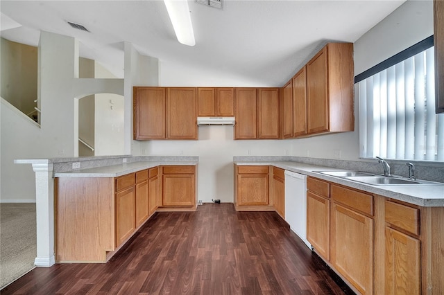 kitchen with sink, dark hardwood / wood-style floors, dishwasher, and vaulted ceiling