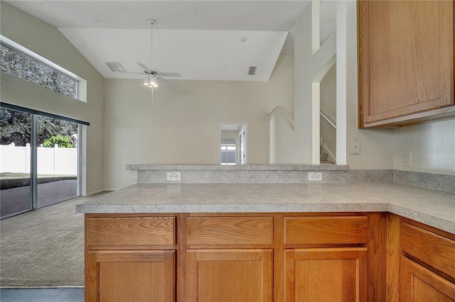 kitchen with vaulted ceiling, light colored carpet, and ceiling fan