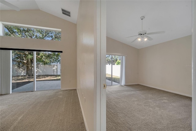 unfurnished room featuring high vaulted ceiling, light colored carpet, and ceiling fan