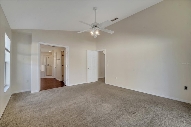 carpeted empty room featuring ceiling fan and high vaulted ceiling