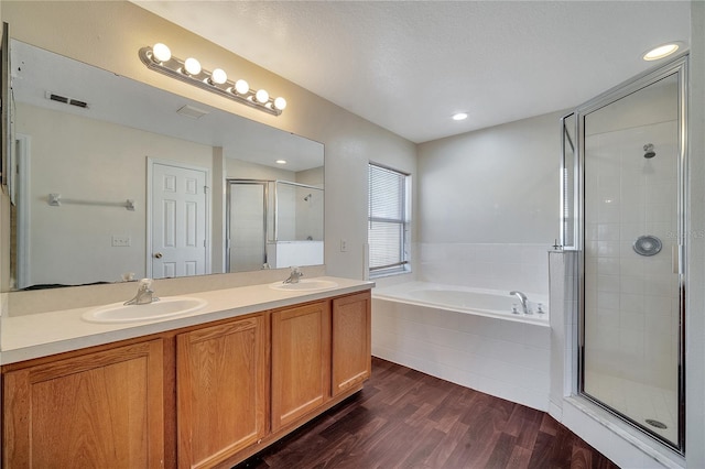 bathroom featuring vanity, separate shower and tub, hardwood / wood-style floors, and a textured ceiling