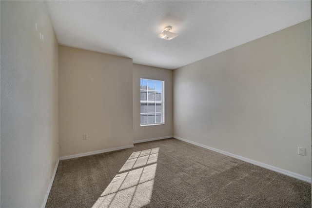 carpeted spare room featuring a textured ceiling