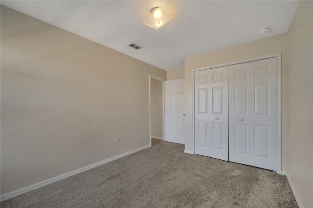 unfurnished bedroom with carpet floors and a closet