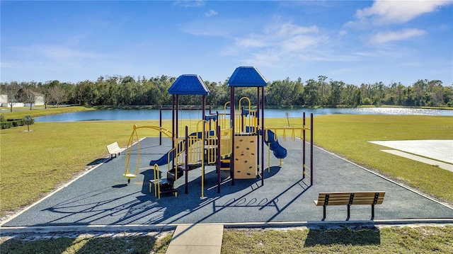 view of playground with a lawn and a water view