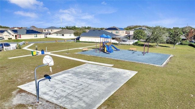 view of jungle gym with basketball hoop and a lawn