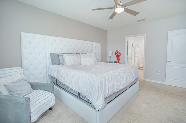 carpeted bedroom with ceiling fan and connected bathroom